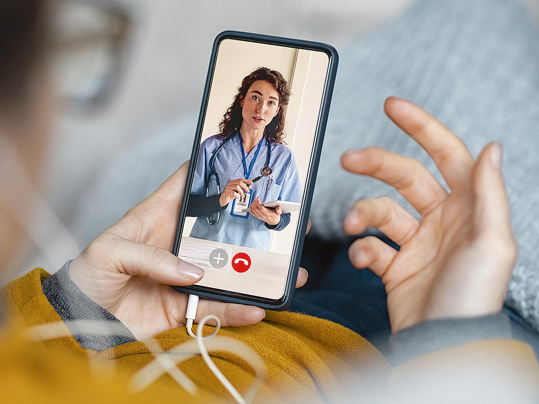 Das Bild zeigt eine Person, die in einem Videoanruf mit einer Ärztin ist.